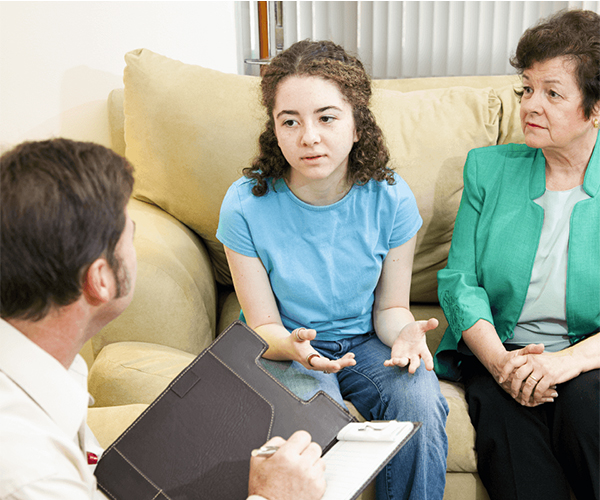 teen sharing her story to a psychologist